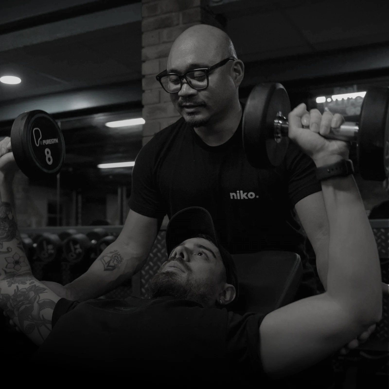 Niko supporting a client during an incline dumbbell press