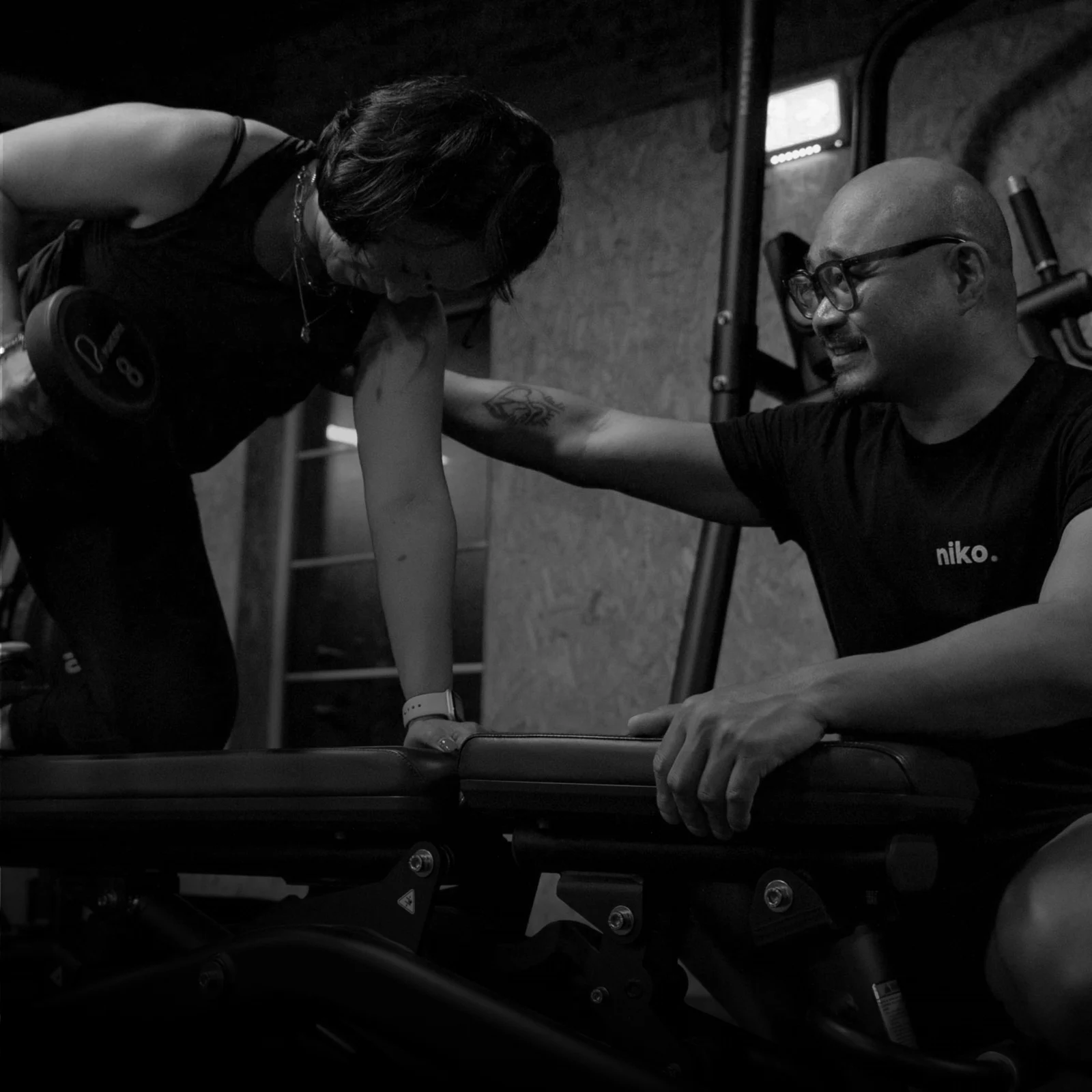 Niko coaching a client through a dumbbell row